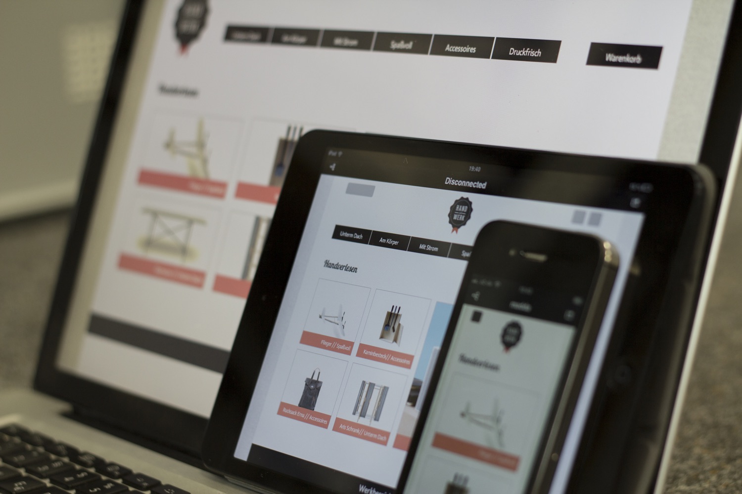 The original Hand und Werk shop prototype shown on a computer, tablet and phone